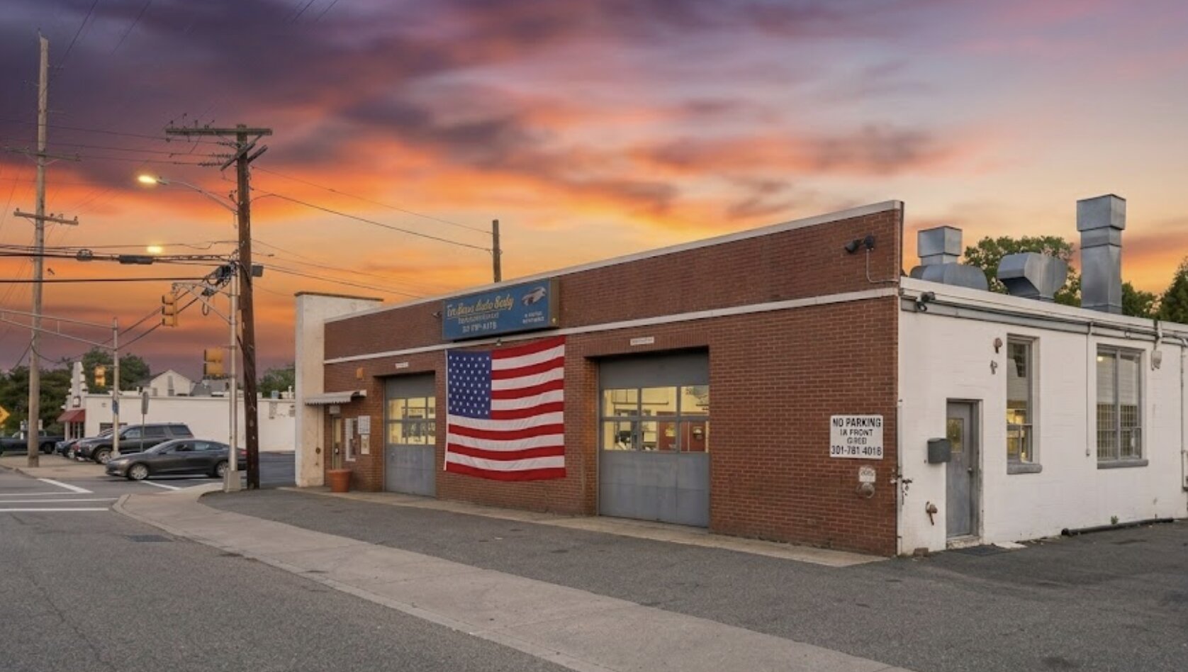 Exterior of Tri-Boro Auto Body shop at dusk